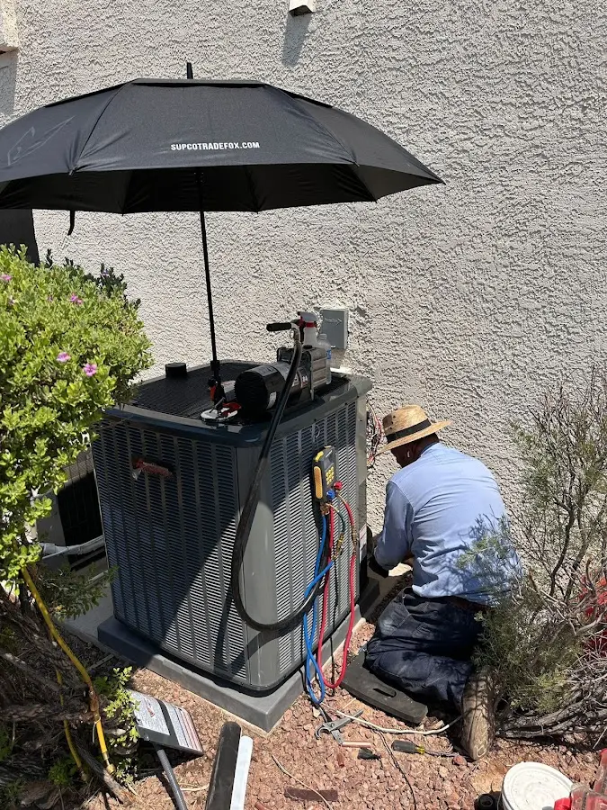 HVAC technician performing outdoor AC maintenance in Mountain Park