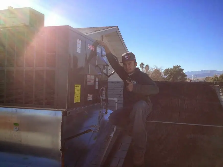 HVAC technician performing HVAC Inspection on a rooftop unit in Mountain Park